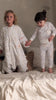 Sibling matching sleepsuit and pajama