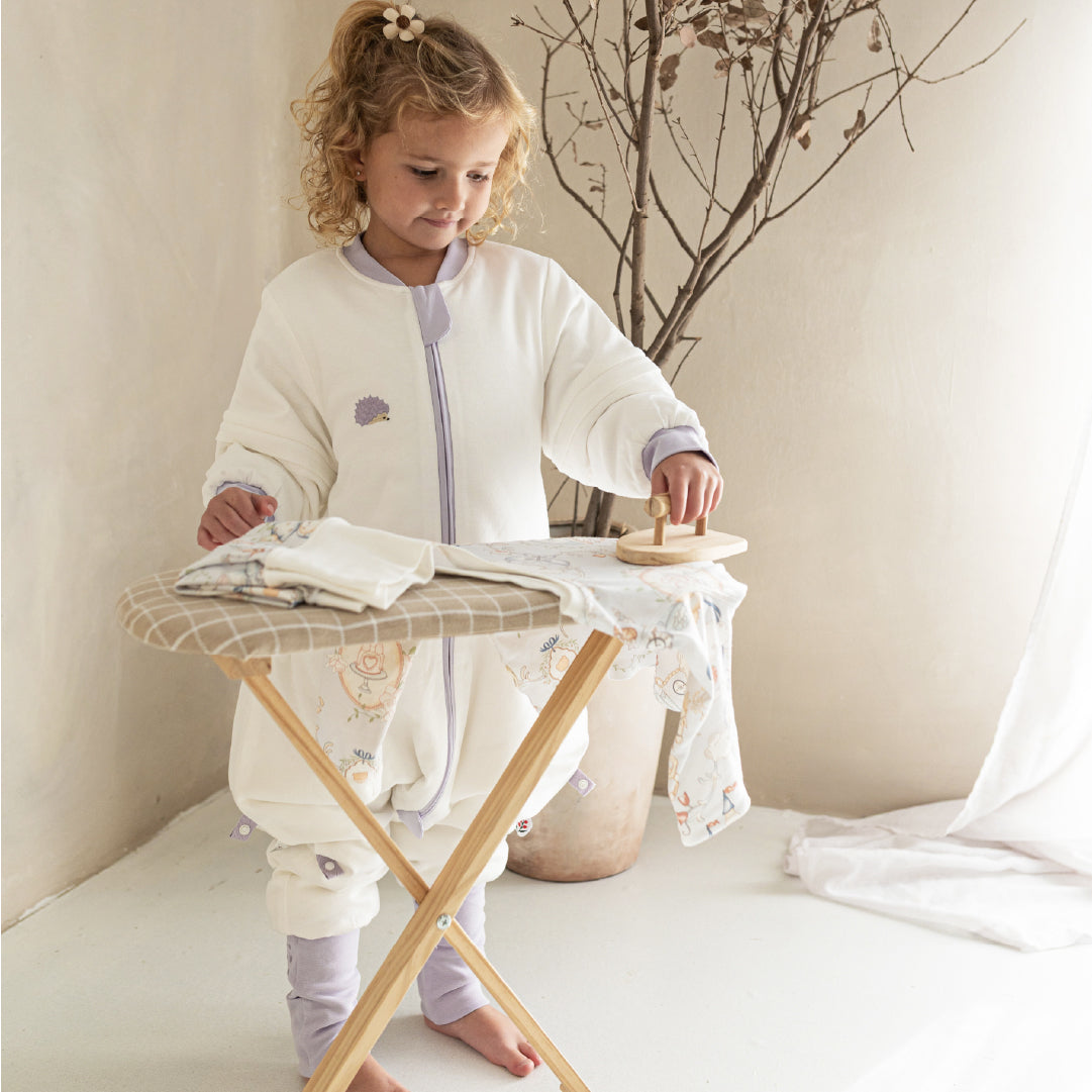 girl playing with vosbos sleepsuits