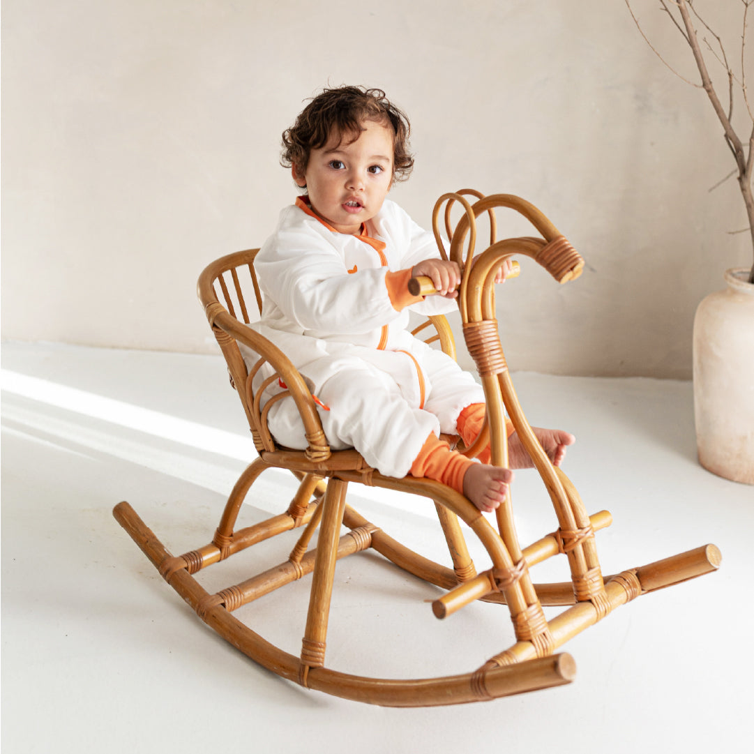 boy play in vosbos sleepsuit orange